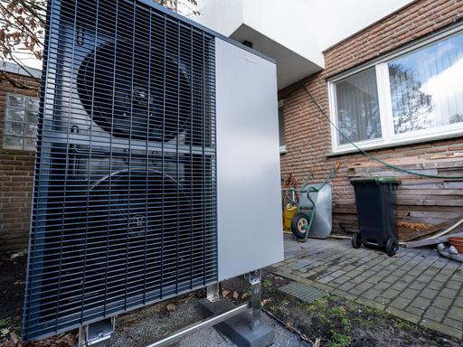 Eine Wärmepumpe der Marke Viessmann steht im Garten eines Einfamilienhauses.